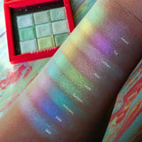 Top angled arm swatches on fair skin tone of Series 1 Iridescent Multichrome Eyeshadow shifts of Ray, Luminaire, Ambient, Flicker, Candela, Illumination, Reflectance, Glare, Umbra