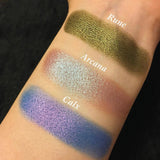 Top angled arm swatches on fair skin tone of Rune Duochrome Eyeshadow compared to Arcana, Calx