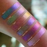 Left angled arm swatches on fair skin tone of Engrave Glitter Multichrome Eyeshadow shifts compared to Abrasion, Grisaille, Glaziers Mark, Kaleidoscope