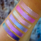 Right angled arm swatches on medium skin tone of Enamel Glitter Multichrome Eyeshadow sifts compared to Translucency, Spotlight, Glazed, Tracery, Stencil
