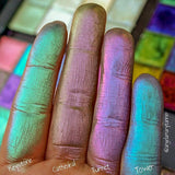 Close up finger swatches of Tower Pastel Multichrome Eyeshadow shifts next to Keystone, Cathedral, Turret