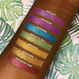 Top angled arm swatches on deep skin tone of Amulet compared to Panacea, Subzero, Gecko's Tail, Beehive, Wildfire and Midnight Sun