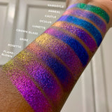 Low angled arm swatches on deep skin tone of Spire Jewelled Multichrome Eyeshadow shifts compared to Gargoyle, Anneal, Castle, Oculus, Lunette, Crown Glass, Rosette, Flame-Blown