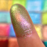 Close up finger swatch on fair skin of Duchess Glitter Vibrant Multichrome Eyeshadow