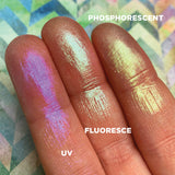 Left angled finger swatches of Phosphorescent Iridescent Multichrome Eyeshadow shifts compared to UV, Fluoresce