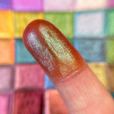 Close up finger swatch on fair skin of Flare Glitter Multichrome Eyeshadow