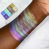 Top angled arm swatches on deep skin tone of Carving Glitter Multichrome compared to Corrosion, Chandelier, Grisaille, Ripple, Ciel, Enamel, Stencil
