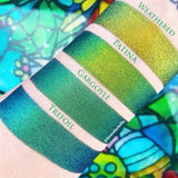 Top angled arm swatches on fair skin tone of Trefoil Jewelled Multichrome Eyeshadow shifts compared to Weathered, Patina, Gargoyle