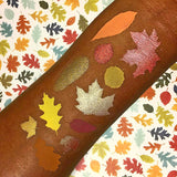 Top angled  leaf arm swatches on deep skin tone of The Harvest Moon Collection including Chamomile Duochrome Eyeshadow