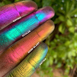 Finger swatches of Sand Blast Jewelled Multichrome Eyeshadow shifts next to Gothic, Oculus, Patina