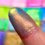 Close up finger swatch on fair skin tone of Hilt Electric Multichrome Eyeshadow