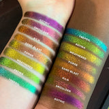 Top angled arm swatches on fair and deep skin tones of Gothic Jewelled Multichrome Eyeshadow shifts compared to Smoulder, Kiln, Sand Blast, Forge, Weathered, Patina, Trefoil
