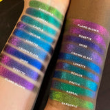 Top angled arm swatches on fair and deep skin tones of Crown Glass Jewelled Multichrome Eyeshadow shifts compared to Gargoyle, Anneal, Castle, Oculus, Lunette, Spire, Rosette, Flame-Blown