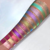 Top angled arm swatches on medium skin tone of Flashed Glass Electric Multichrome Pigment shifts compared to Mural, Motif, Emblem, Tessera, Hilt, Niello, Quest, Rayonnant, Cinder, Oriel and Signet