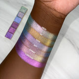 Top angled arm swatches on deep skin tone of Hilt Electric Multichrome Eyeshadow shifts compared to Emblem, Tessera, Quest, Rayonnant and Flashed Glass