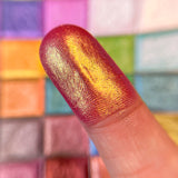 Close up finger swatch on fair skin of Monarch Vibrant Multichrome Eyeshadow