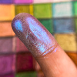 Close up finger swatch on fair skin tone of Radiance Series 2 Iridescent Multichrome Eyeshadow
