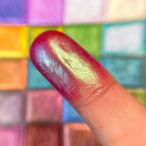Close up finger swatch on fair skin of Reign Vibrant Multichrome Eyeshadow
