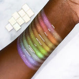 Top angled arm swatches on deep skin tone of Phosphorescent Series 2 Multichrome compared to Aura, Ray, Halo, Chromatic, Spectrum, Lux, Fluoresce, UV