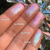Low angled finger swatches on fair skin tone of Glow Glitter-Type Iridescent Multichrome Eyeshadow shifts compared to Glimmer, Glisten, Glare