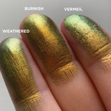 Left angled finger swatches of Vermeil Jewelled Multichrome Eyeshadow shifts compared to Burnish, Weathered