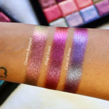 Straight angled arm swatches on medium skin tone of Queen's Banquet Hybrid Multichrome Eyeshadow shifts compared to King's Feast and Coat of Arms
