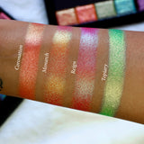 Straight angled arm swatches on medium skin tone of Reign Multichrome Eyeshadow shifts compared to Coronation, Monarch and Topiary
