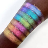 Top angled arm swatches on deep skin tone of Viridian Deep Iridescent Multichrome Eyeshadow shifts compared to Lapis Lazuli, Cerulean, Citron, Cerise, Saffron and Auric