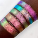 Top angled arm swatches on deep skin tone of Duchess Glitter Vibrant Multichrome Eyeshadow shifts compared to Nobel, Diadem, Court Jester and Empress