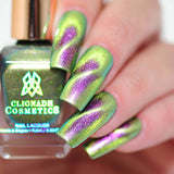 Close up of nails done with Toxic Sludge Nail Lacquer featuring a design to show off the magnetic effect on fair skin tone.