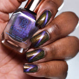Close up of nails done with Distortion Nail Lacquer featuring a line showing off the magnetic effect on deep skin tone