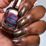 Close up of nails done with Synesthesia Nail Lacquer featuring a line to show off the magnetic effect on deep skin tone