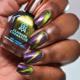 Close up of nails done with Toxic Sludge Nail Lacquer featuring a design to show off the magnetic effect on deep skin tone