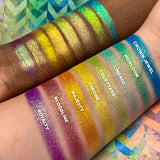 Top angled arm swatches on deep and fair skin tone of Majesty Vibrant Multichrome Eyeshadow shifts next to Crown Jewel, Heirloom, Lineage, Courtyard, Throne, Bloodline, Royalty