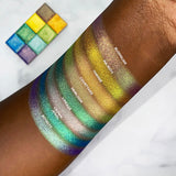 Top angled arm swatches on deep skin tone of Vibrant Multichrome Eyeshadow Bundle
