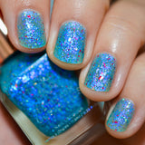 Close-up shot of Blue Hawaiian nail lacquer applied to finger nails, with nail lacquer bottle in hand