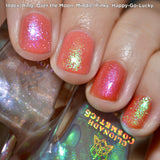 Close up shot of nails done with Over the Moon and Happy-Go-Lucky Nail Lacquers over an orange base on fair skin tone.