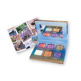 Galápagos Palette propped open displaying shadows with palette packaging visible behind on a white background.