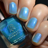 Close-up of nails painted with Ginto Nail Lacquer on fair skin tone. Hand is holding polish bottle.