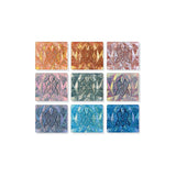 Nine shades of eyeshadow from the 2025 Holiday Countdown Box, shown as single shadows, on a white background.