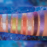 Arm swatches on medium skin tone of all 8 shadows included in the Deep Sea Treasures Palette. Left to right: Saltwater Pearl, The Bends, Fool's Gold, Kelp Forest, Ring of Fire, Cephalopod, Shipwreck and S.C.U.B.A.