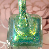 Top angled shot of opened Ophelia Nail Lacquer bottle with the brush showing.
