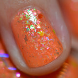 Close up shot of one nail done with Pumpkin Guts Nail Lacquer on fair skin tone.