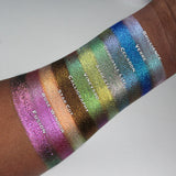 Arm swatches of Vineyard as well as the other 9 Holiday Countdown Box shadows on deep skin tone.