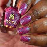 Close-up shot of Strawberry Mojito nail lacquer applied to finger nails on a darker skin tone, with nail lacquer bottle in hand