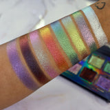 Arm swatches on medium skin tone of all 8 shadows included in the Deep Sea Treasures Palette. Right to left: Saltwater Pearl, The Bends, Fool's Gold, Kelp Forest, Ring of Fire, Cephalopod, Shipwreck and S.C.U.B.A.