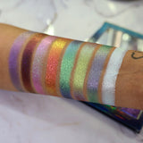 Arm swatches on medium skin tone of all 8 shadows included in the Deep Sea Treasures Palette. Right to left: Saltwater Pearl, The Bends, Fool's Gold, Kelp Forest, Ring of Fire, Cephalopod, Shipwreck and S.C.U.B.A.