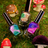 Psilo-Siblings Nail Lacquer Trio laying on a bed of grass surrounded by mushroom figures.