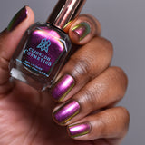 Close up shot of nails done with Smoulder Lite nail lacquer on deep skin tone holding the nail lacquer bottle