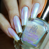 Close up shot of nails done with Radiance nail lacquer on fair skin tone holding the nail lacquer bottle